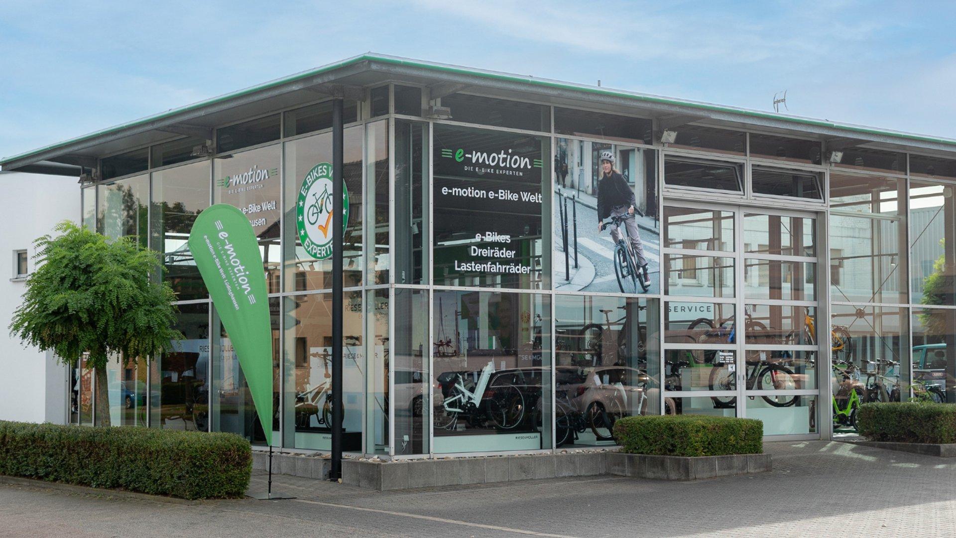 Das Bild zeigt ein modernes E-Bike Fachgeschäft mit großen Glasfenstern