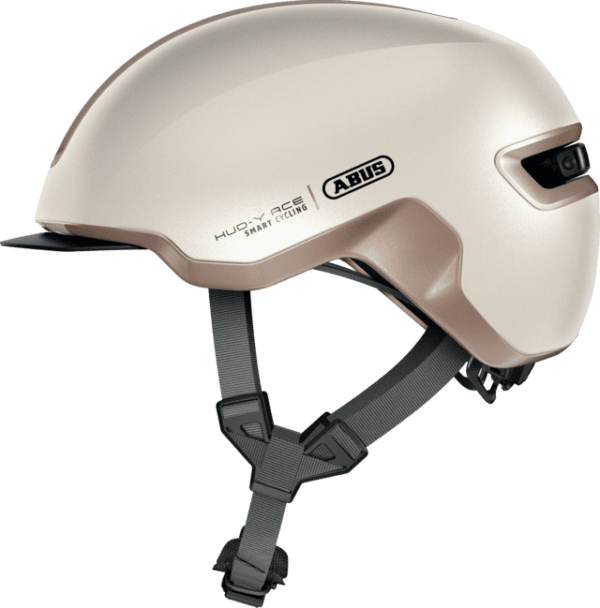 Eleganter ABUS HUD-Y ACE Helm in Champagne Gold für smarte Radfahrer. Bietet optimalen Schutz und Stil für jede Fah